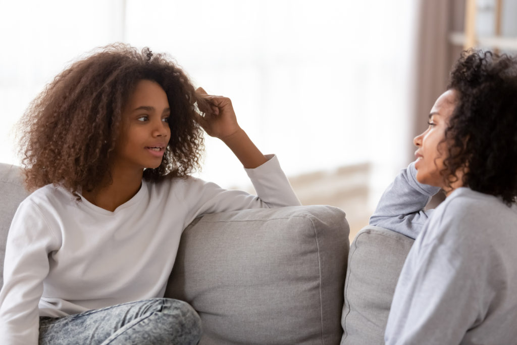 Parent discussing sexual health in teens with her daughter